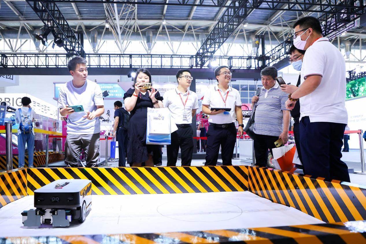 講解員向觀眾介紹智能劃線機(jī)器人。來源：受訪方供圖