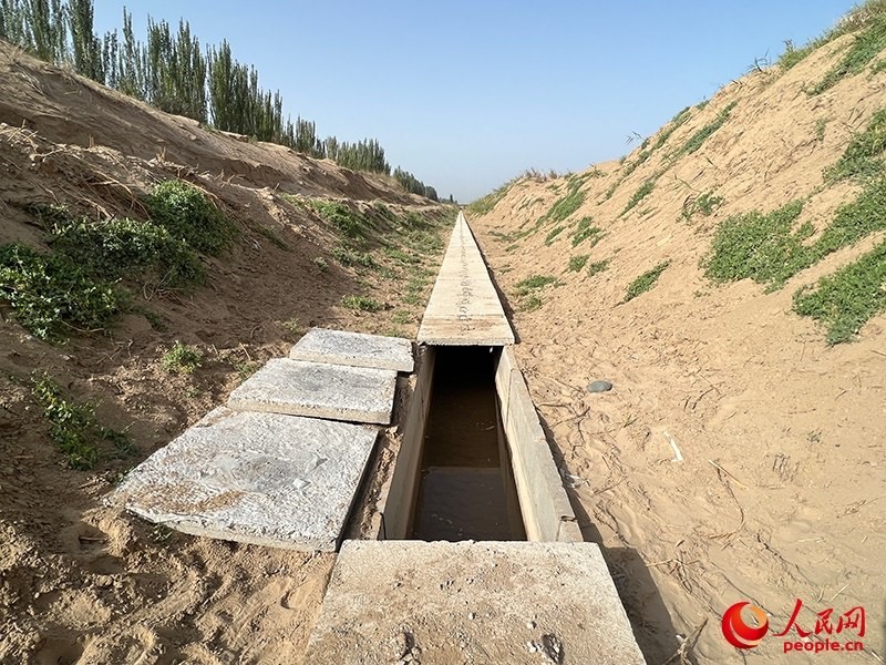 打開(kāi)蓋板，可見(jiàn)水在寬一米、深一米的渠道內(nèi)暢通流過(guò)。人民網(wǎng)記者 常雪梅攝