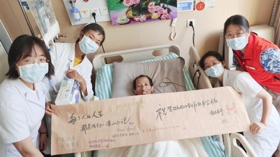 7月26日，海淀醫(yī)院安寧療護(hù)科醫(yī)護(hù)團(tuán)隊(duì)為朱銳送來(lái)一條寫(xiě)滿祝福的橫幅。（受訪者供圖）