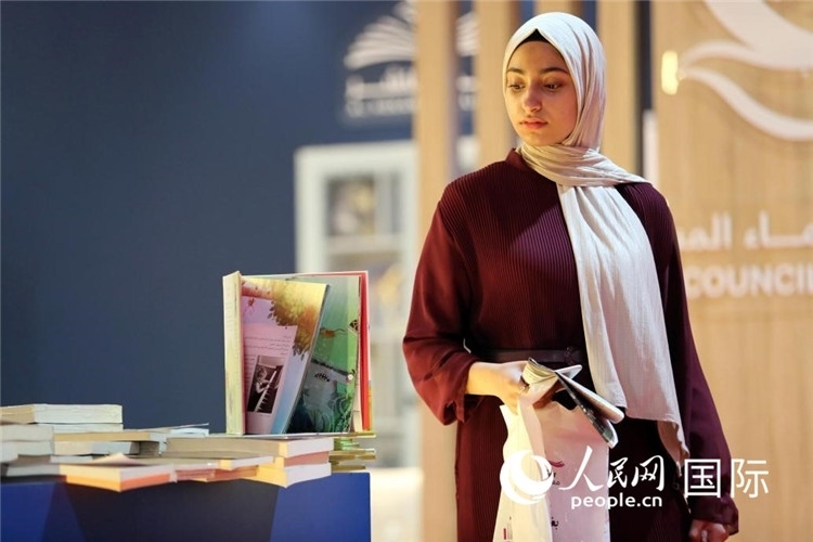 一名女性走過展臺。人民網(wǎng) 奧馬爾·哈利勒攝