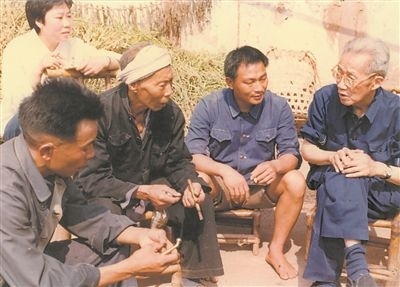 侯光炯（右一）和農(nóng)民在一起親切交流。 西南大學(xué)檔案館供圖